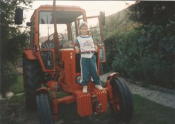 Balázs Fábián standing on his granddad’s tractor.